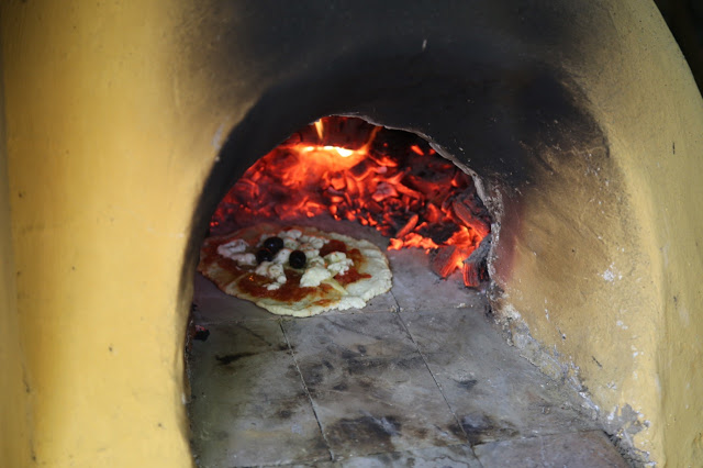 Making pizza in a wood fired cob oven, Norfolk