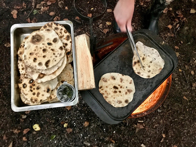 Cooking flat breads on the fire, pure food camp, Skane, Sweden