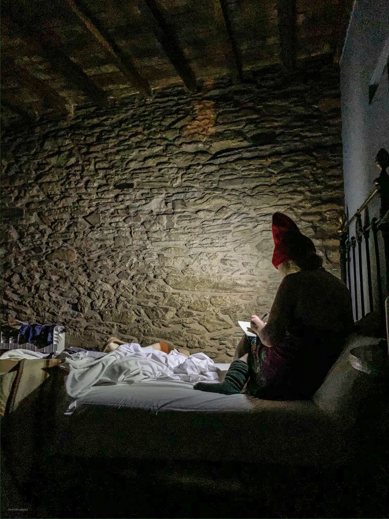 my sister stretching and writing her diary in the early dawn, camino de Santiago pic: Kerstin rodgers/msmarmitelover.com
