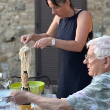 Emily O'Hare serving pasta at an al fresco dinner in La Torre Alle Tolfe, just outside Siena in Tuscany pic; Kerstin Rodgers